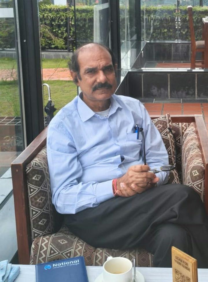 Professor Amar Kumar Mishra seated by a window